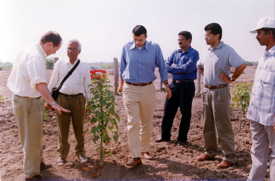Founder reviewing a cotton plot with international agronomy experts and the local farm team