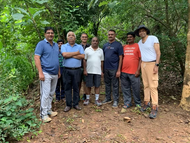 Founder walking the forest line with the Agropolis project team during a site survey